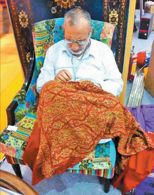 An artisan from Kashmir demonstrates embroidery craftsmanship at the booth of Splendid Kashmir Art during the ICIF in 2015.